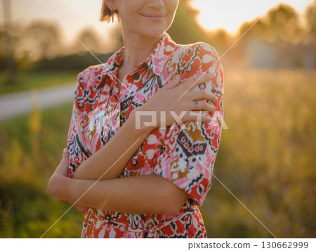 boho chic woman in a floral dress in European countryside boho chic woman in a floral dress in European countryside 130662999
