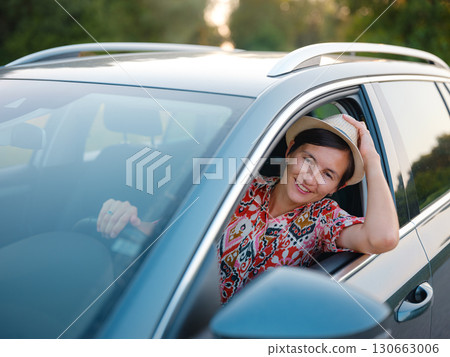 Traveler woman drives car through scenic countryside of Croatia 130663006