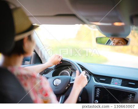Traveler woman drives car through scenic countryside of Croatia 130663007