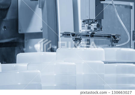 Automatic material handling process on the injection mold machine in the blue tone scene. Automatic material handling process on the injection mold machine in the blue tone scene. 130663027