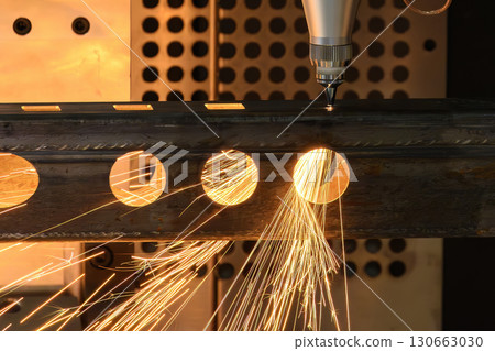 Close up scene the fiber laser cutting machine cut the square shape stainless steel tube with sparkling light. Close up scene the fiber laser cutting machine cut the square shape stainless steel tube with sparkling light. 130663030