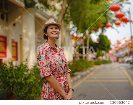 woman exploring streets of George Town, during Chinese New Year. woman exploring streets of George Town, during Chinese New Year. 130663042