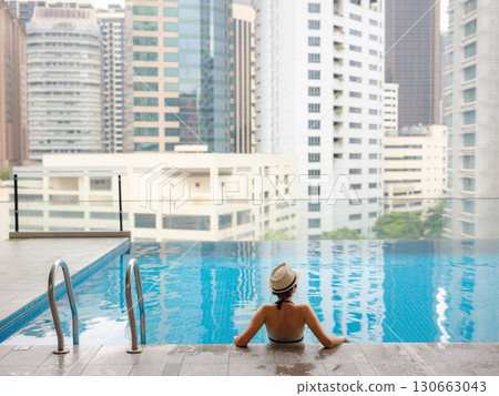 Young woman relaxing by the pool at a Kuala Lumpur hotel 130663043