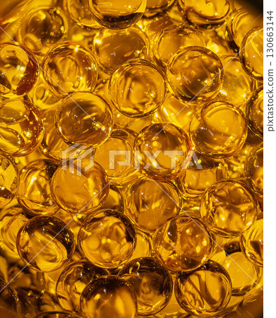 Background of golden round omega-3 capsules Background of golden round omega-3 capsules 130663144