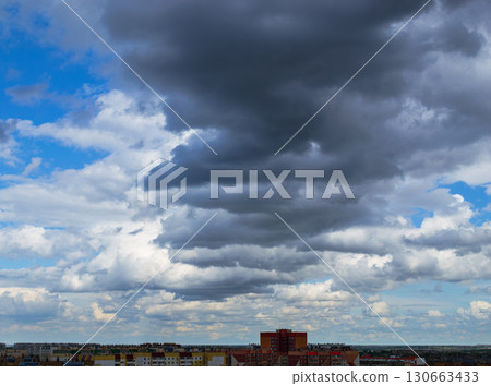 Cloudy sky over city apartment buildings Cloudy sky over city apartment buildings 130663433