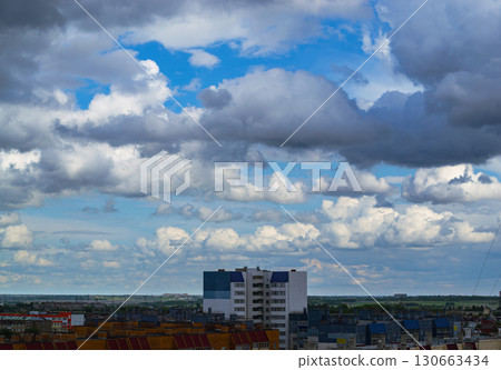 Cloudy sky over city apartment buildings 130663434