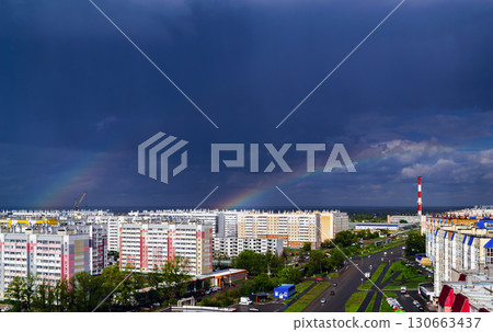Double rainbow over city buildings after rain 130663437