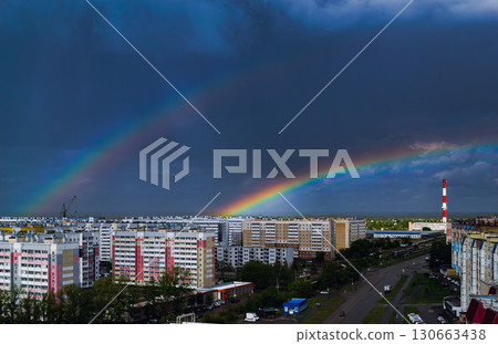 Double rainbow over city buildings after rain Double rainbow over city buildings after rain 130663438