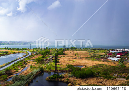 Heavy rainfall over countryside near lake Heavy rainfall over countryside near lake 130663458