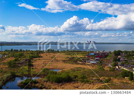 Power plant by lake under bright beautiful clouds Power plant by lake under bright beautiful clouds 130663484
