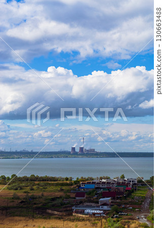 Power plant by lake under bright beautiful clouds Power plant by lake under bright beautiful clouds 130663488