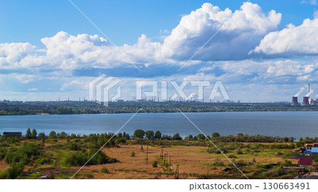 Power plant by lake under bright beautiful clouds Power plant by lake under bright beautiful clouds 130663491