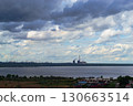 Storm clouds over lake and industrial skyline 130663514