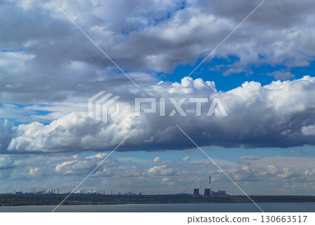 Storm clouds over lake and industrial skyline with power plant 130663517
