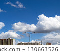 White clouds over street lights and apartment buildings 130663526