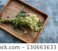 Bouquet of fresh flowers of meadowsweet  on the wooden box background  130663633