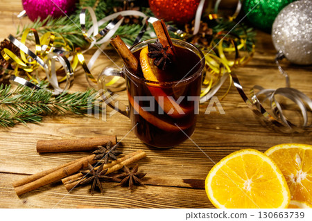 Christmas mulled wine with spices and Christmas decoration on wooden table Christmas mulled wine with spices and Christmas decoration on wooden table 130663739