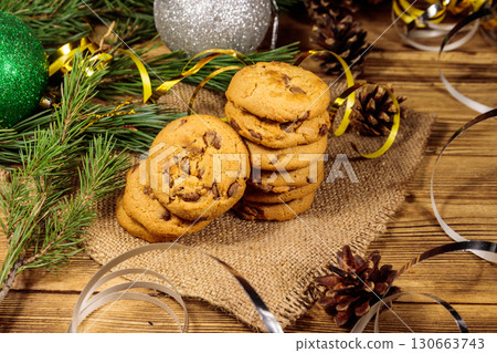 Chocolate chip cookies with Christmas decoration on wooden table 130663743