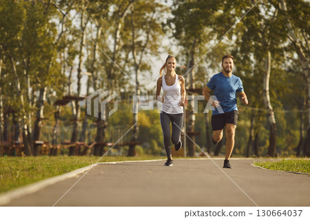 Happy Couple Jogging in the City Park Happy Couple Jogging in the City Park 130664037