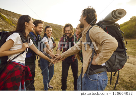 Team of happy friends huddling and having fun on their hiking or trekking holiday Team of happy friends huddling and having fun on their hiking or trekking holiday 130664052