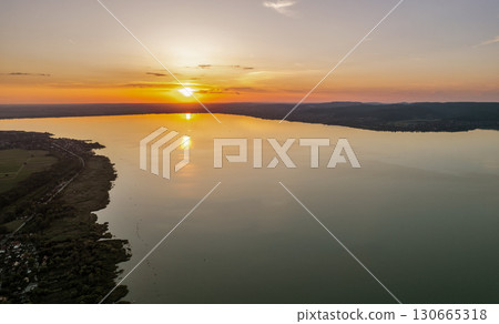 Spectacular sunset over lake Balaton with golden reflections, Hungary. Spectacular sunset over lake Balaton with golden reflections, Hungary. 130665318