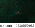 Aerial top nature view above green turquoise Adriatic sea in Albania. young woman swimming alone 130665968