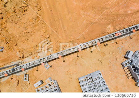 Aerial view of construction site with concrete blocks sand, materials prepared for building. Aerial view of construction site with concrete blocks sand, materials prepared for building. 130666730