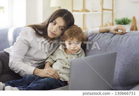 Mother and son watching cartoon for child development via laptop computer 130666731