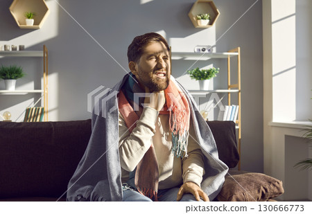 Unhealthy young man feels severe pain and sore throat, malaise and weakness. Unhealthy young man feels severe pain and sore throat, malaise and weakness. 130666773
