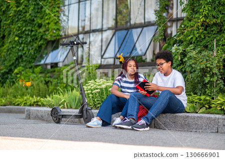 Two teens discussing something after school and looking involved 130666901