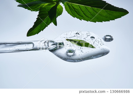 A drop of natural cosmetics with a mint leaf. 130666986
