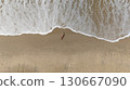 Pregnant Woman Relaxing by the Ocean Aerial Beach Photography 130667090
