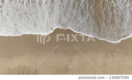 Pregnant Woman Relaxing by the Ocean Aerial Beach Photography 130667090