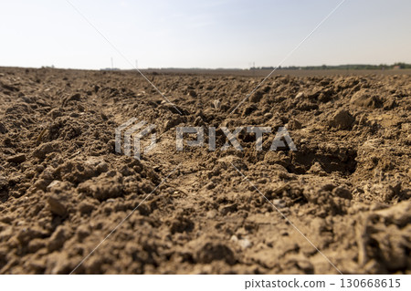 a field after harvest, a large field where agricultural activity is carried out in Europe 130668615