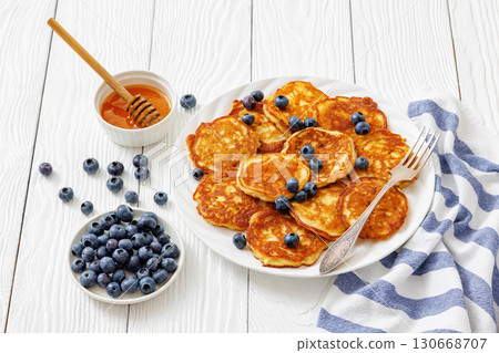 fried hot and crispy pancakes with blueberries 130668707