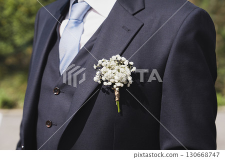 Groom with gypsophila flowers boutonniere at a wedding Groom with gypsophila flowers boutonniere at a wedding 130668747