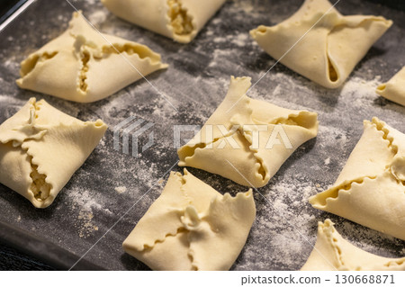 Close up shot of the cottage cheese pastries on the baking tray. Food Close up shot of the cottage cheese pastries on the baking tray. Food 130668871