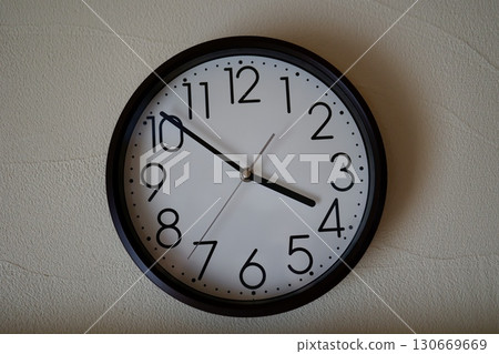 A wall clock showing just before 4 o'clock and an image of evening time 130669669