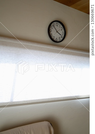 A wall clock showing just before 4 o'clock and an image of evening time 130669671