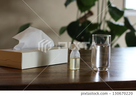 Tissue paper, a cup of water, a syrup container, an image of taking medicine, flowers Tissue paper, a cup of water, a syrup container, an image of taking medicine, flowers 130670220