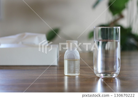 Tissue paper, a cup of water, a syrup container, an image of taking medicine, flowers Tissue paper, a cup of water, a syrup container, an image of taking medicine, flowers 130670222