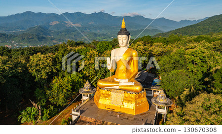Aerial view of A golden Buddha statue on the mountains at Fang Chiang Mai 130670308