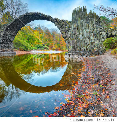 Breathtaking autumn landscape in Kromlau Rhododendron Park . Rakotz Bridge (Rakotzbrucke, Devil's Bridge) Breathtaking autumn landscape in Kromlau Rhododendron Park . Rakotz Bridge (Rakotzbrucke, Devil's Bridge) 130670914