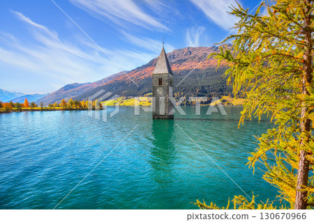 Astonishing autumn lake landscape with submerged bell tower in lake Resia or Reschensee. 130670966