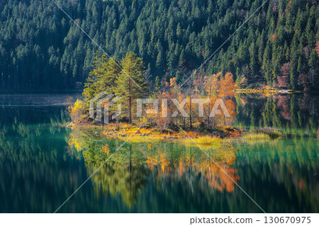 Fabulous autumn landscape of islands with pine-trees in the middle of Eibsee lake. Fabulous autumn landscape of islands with pine-trees in the middle of Eibsee lake. 130670975