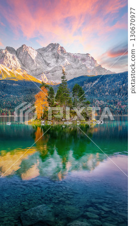 Astonishing autumn landscape of Eibsee Lake in front of Zugspitze summit under sunset 130670977
