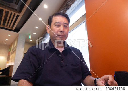 Senior man relaxing at a fast food restaurant 130671138