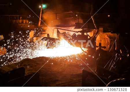 Molten iron stream in a steel mill. Molten iron stream in a steel mill. 130671328