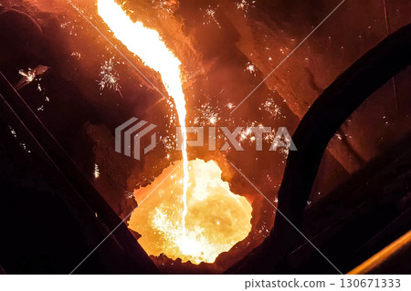 Molten iron stream in a steel mill. 130671333