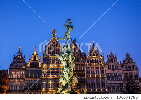 Grote Markt (Main Square) in Antwerp, Belgium, at dusk with the illuminated Renaissance City Hall and the Brabo Fountain statue at the center, captured in the beautiful twilight light. Grote Markt (Main Square) in Antwerp, Belgium, at dusk with the illuminated Renaissance City Hall and the Brabo Fountain statue at the center, captured in the beautiful twilight light. 130671769